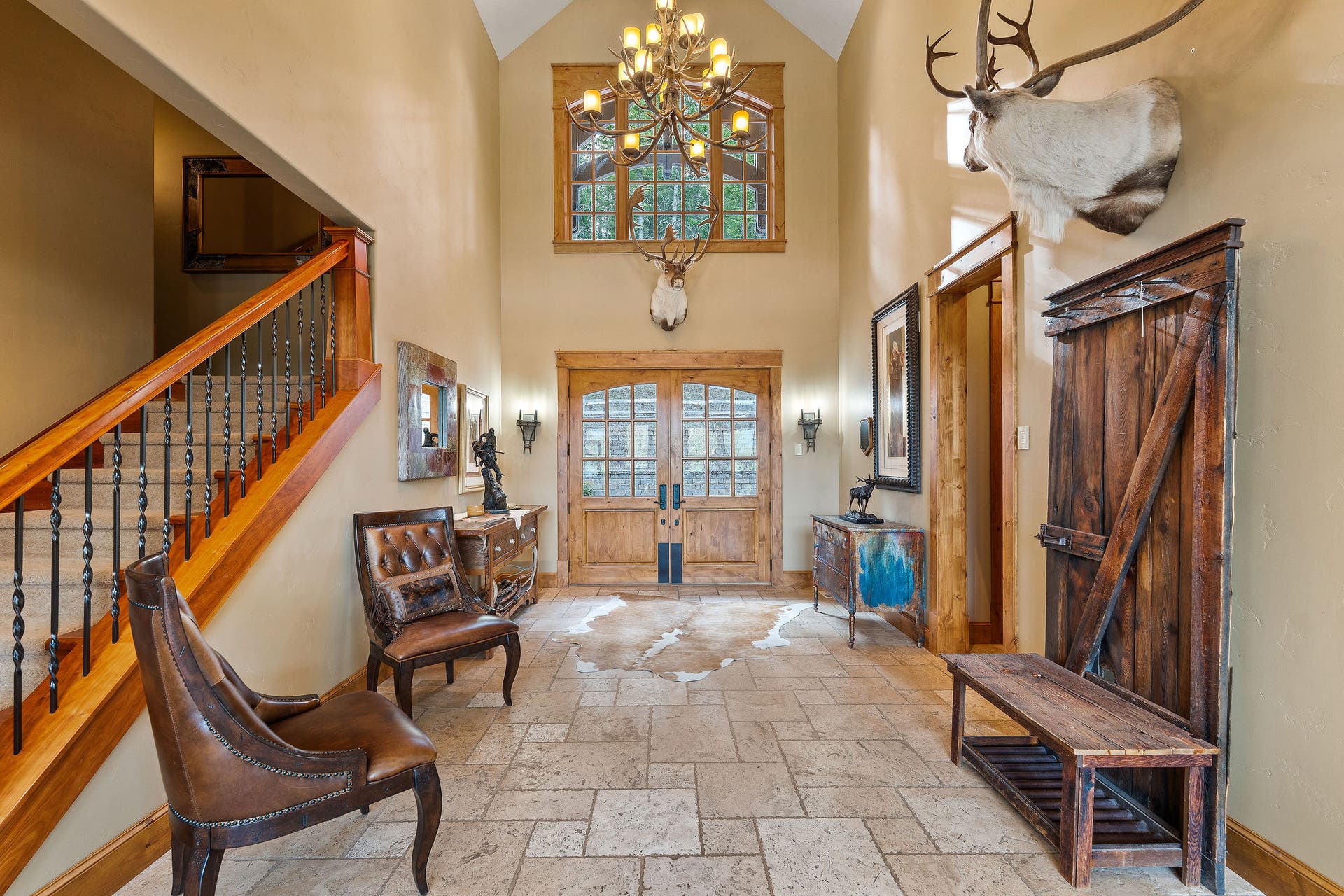 310 Rocky Woods Lane, Bigfork, MT 59911 Custom knotty alder double French doors, tile flooring, antler chandelier