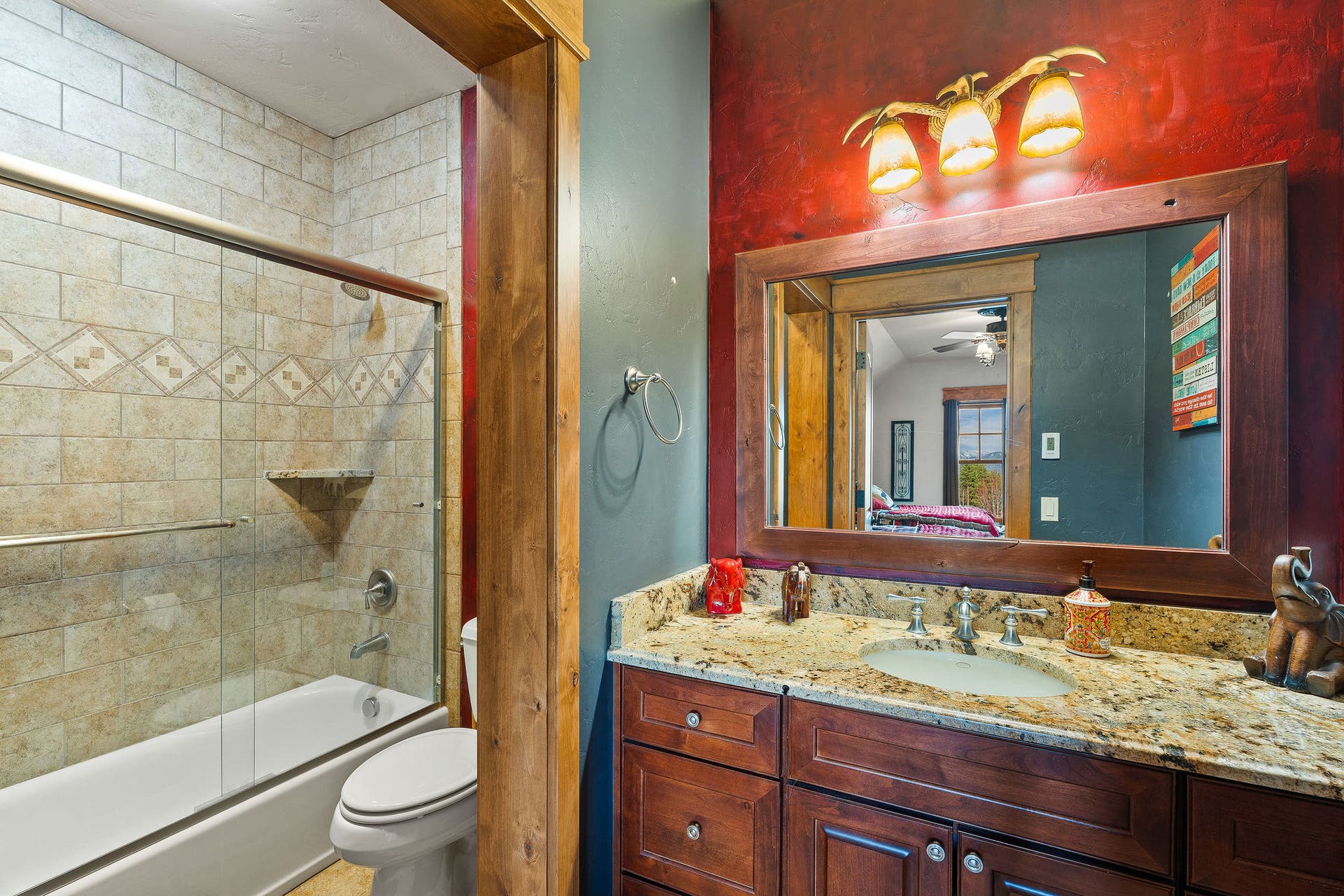 310 Rocky Woods Lane, Bigfork, MT 59911 Full bath ensuite to Guest Bedroom #1 with radiant tile floor, granite countertops