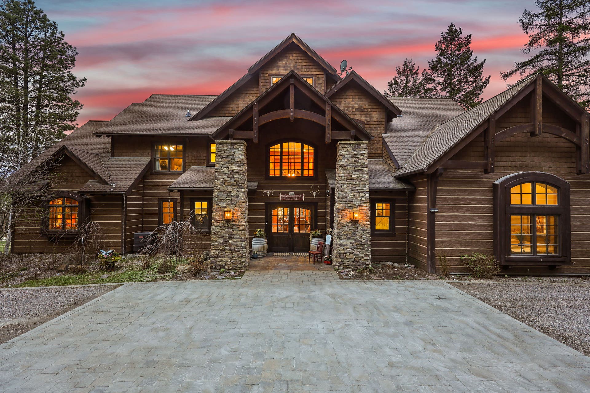 310 Rocky Woods Lane, Bigfork, MT 59911 Two stone pillars frame a grand covered front patio