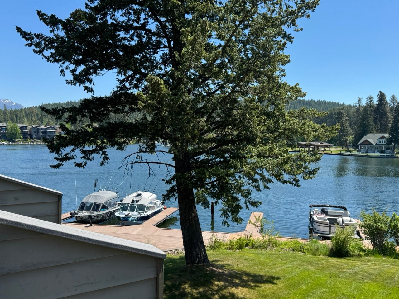 Expansive waterfront property featuring a private dock and a manicured lawn