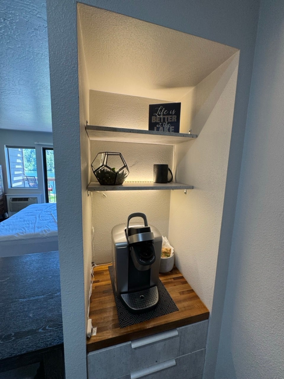 Built-in shelving unit featuring integrated lighting and a wood-finish countertop