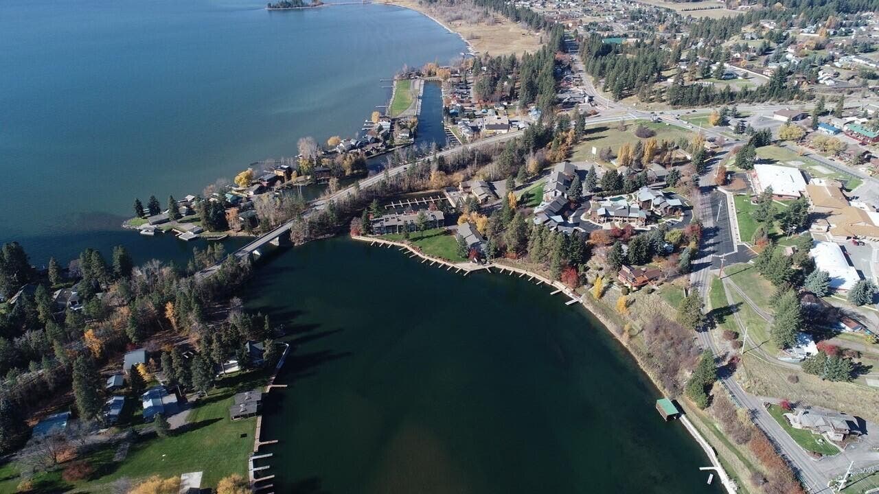 Expansive aerial perspective showcasing waterfront properties, a large body of water, and surrounding topography