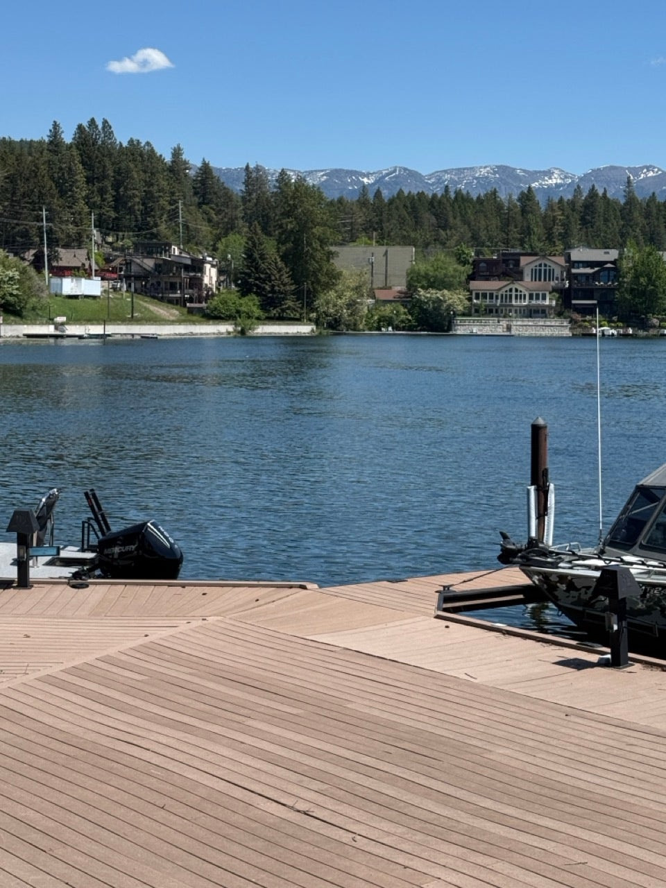 Expansive wood-finish dock with a boat lift, offering direct water access