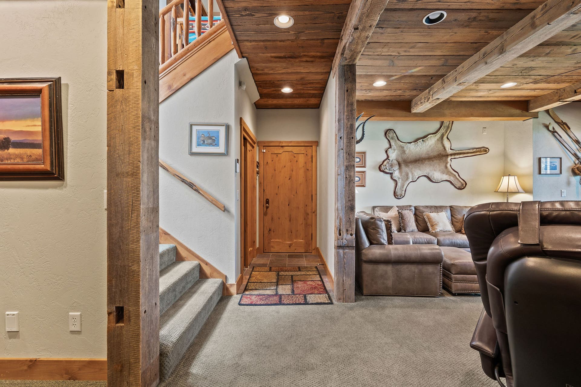 599 Pommel Drive, Bigfork, MT 59911 Timber and beam framing with wood paneled ceilings downstairs