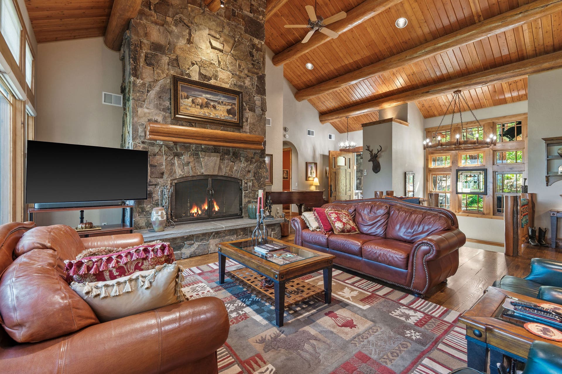 599 Pommel Drive, Bigfork, MT 59911 Great room with grand stone fireplace, tongue & groove ceilings and an amazing view