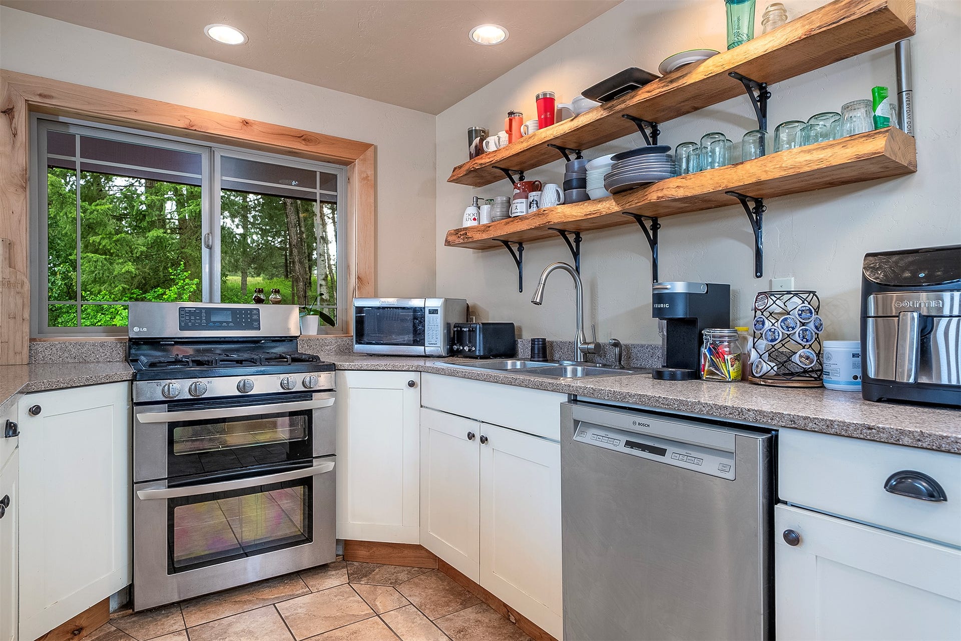 777 Mt Highway 83, Bigfork, MT 59911 Kitchen with white cabinetry, wood-finish open shelving, and granite countertops
