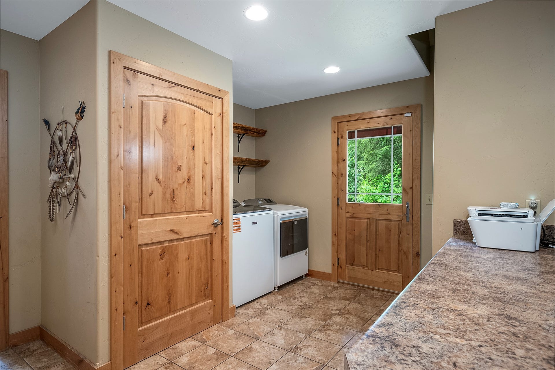 777 Mt Highway 83, Bigfork, MT 59911 Utility area featuring a wood-panel door with glass inserts, recessed lighting, and a countertop space