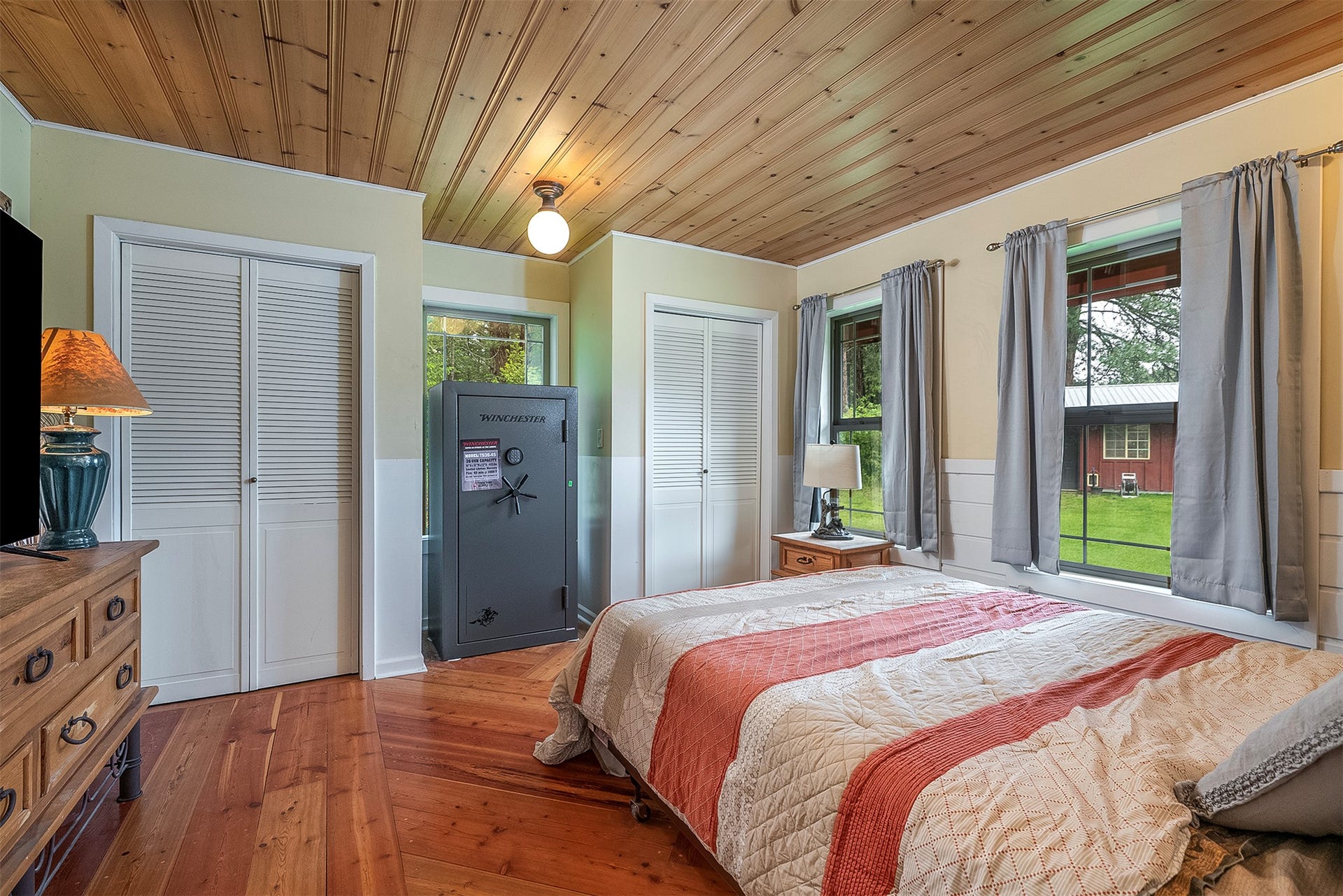 777 Mt Highway 83, Bigfork, MT 59911 Room featuring wood-finish flooring, natural wood plank ceiling, and dual louvered closet doors