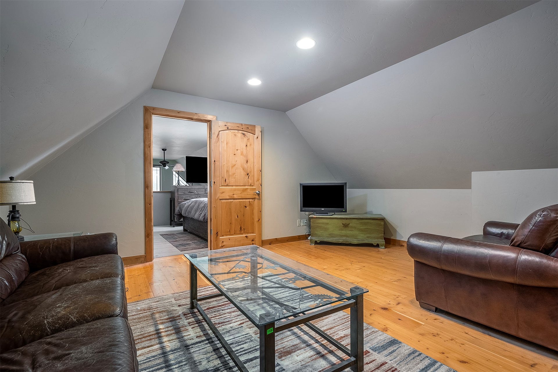 777 Mt Highway 83, Bigfork, MT 59911 Attic living space featuring natural wood-finish flooring, recessed lighting, and a sloped ceiling