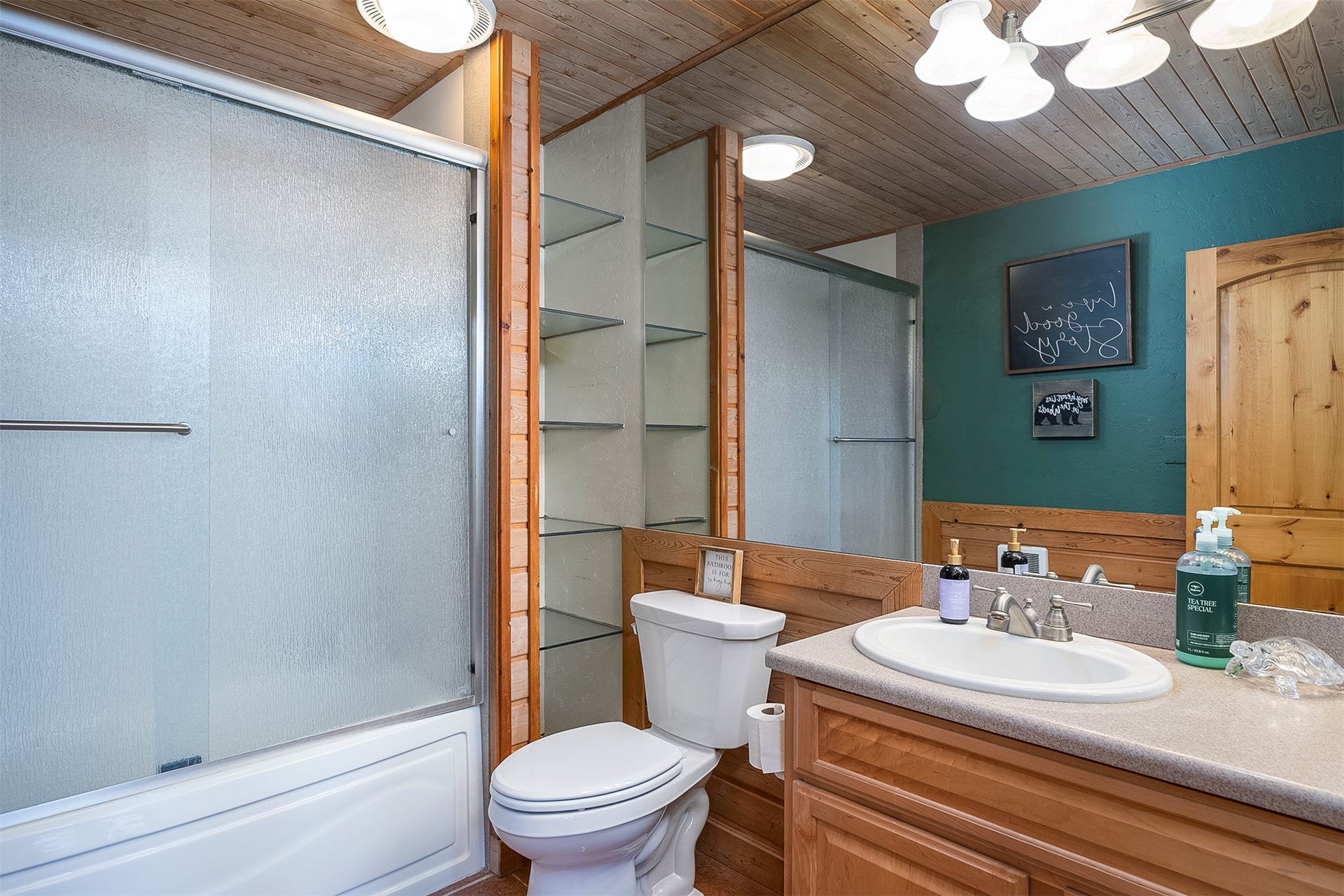 777 Mt Highway 83, Bigfork, MT 59911 Bathroom featuring a built-in vanity with light-colored countertop, an undermount sink, and a large mirror