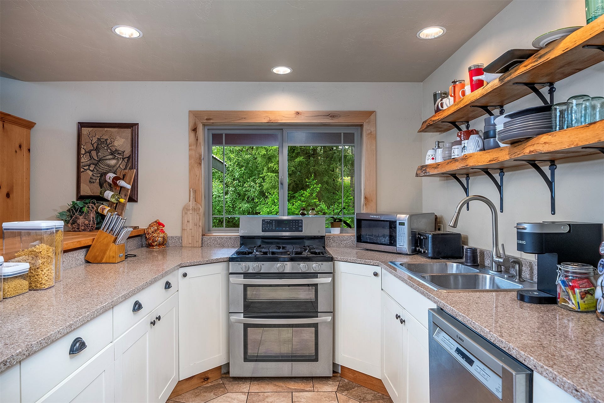 777 Mt Highway 83, Bigfork, MT 59911 Kitchen featuring white cabinetry, granite-style countertops, a stainless steel gas range with double ovens, and a stainless steel dishwasher