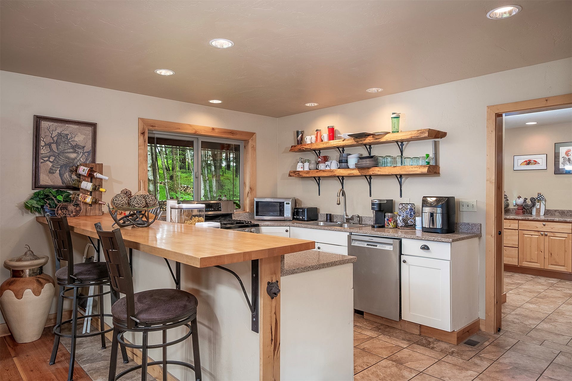 777 Mt Highway 83, Bigfork, MT 59911 Kitchen featuring a wood-finish peninsula with seating, recessed lighting, and open shelving