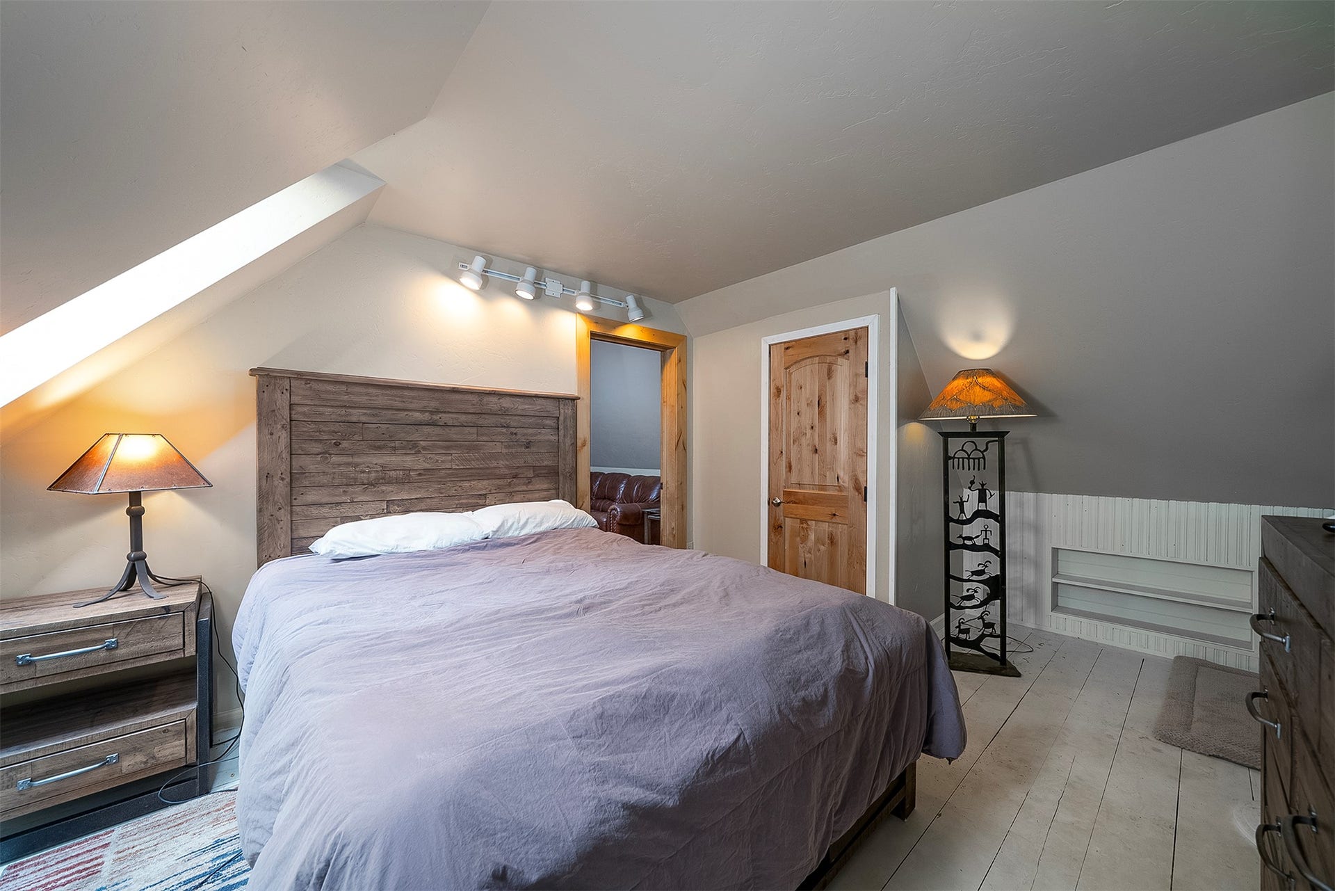 777 Mt Highway 83, Bigfork, MT 59911 Attic room with sloped ceiling, wood-finish flooring, and built-in shelving