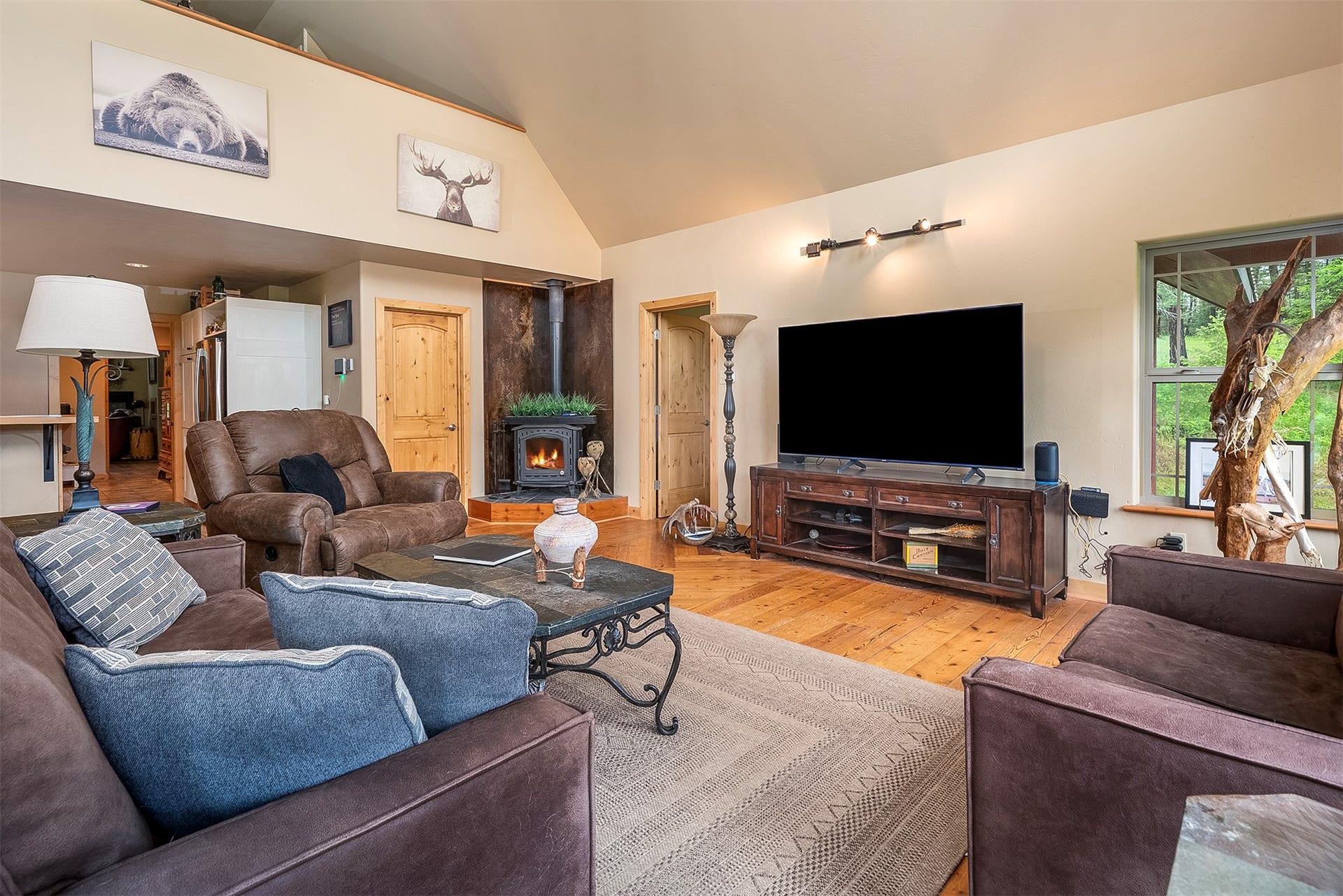 777 Mt Highway 83, Bigfork, MT 59911 Vaulted ceilings complement the wood-finish flooring in this living area