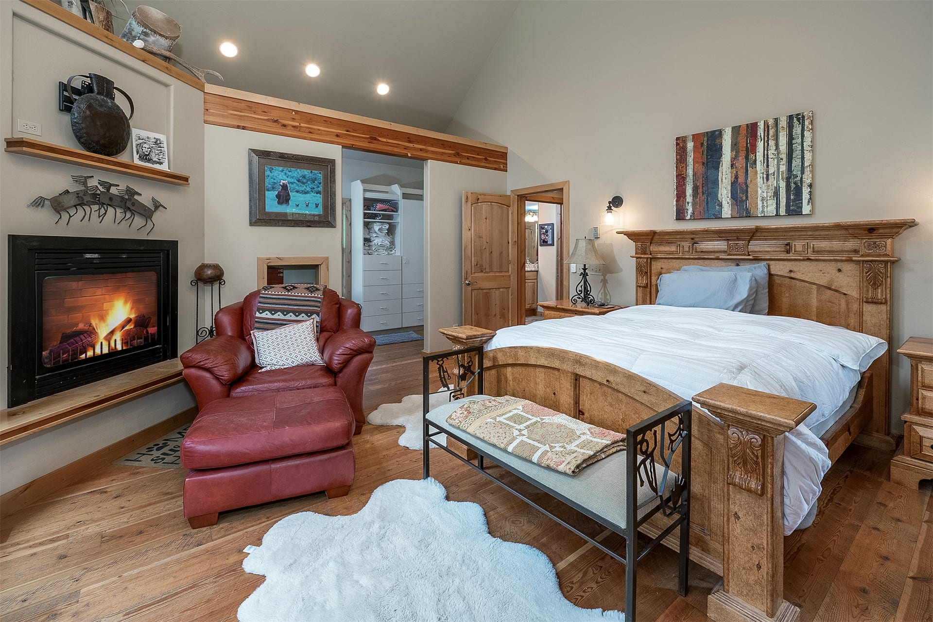777 Mt Highway 83, Bigfork, MT 59911 Interior space featuring wood-finish flooring, a built-in fireplace with a hearth, recessed lighting, and a vaulted ceiling