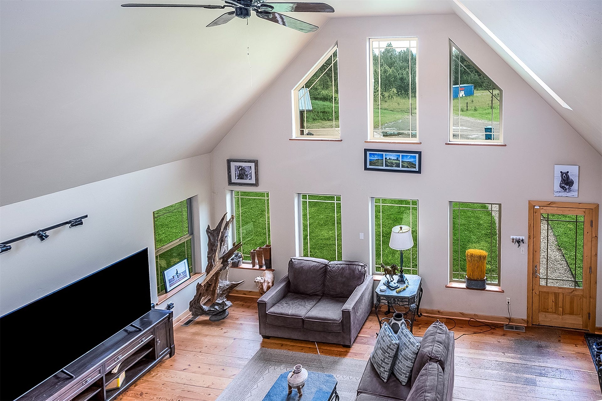 777 Mt Highway 83, Bigfork, MT 59911 Vaulted ceiling great room with a ceiling fan and track lighting