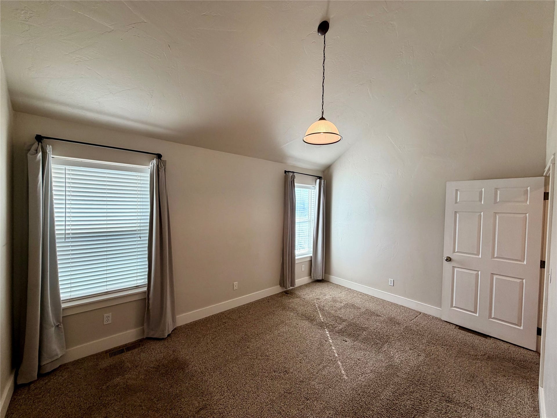 2 Empire Loop, Kalispell, MT 59901 Spacious main level primary suite bedroom with walk-in closet in a 3-bedroom North Kalispell townhome.