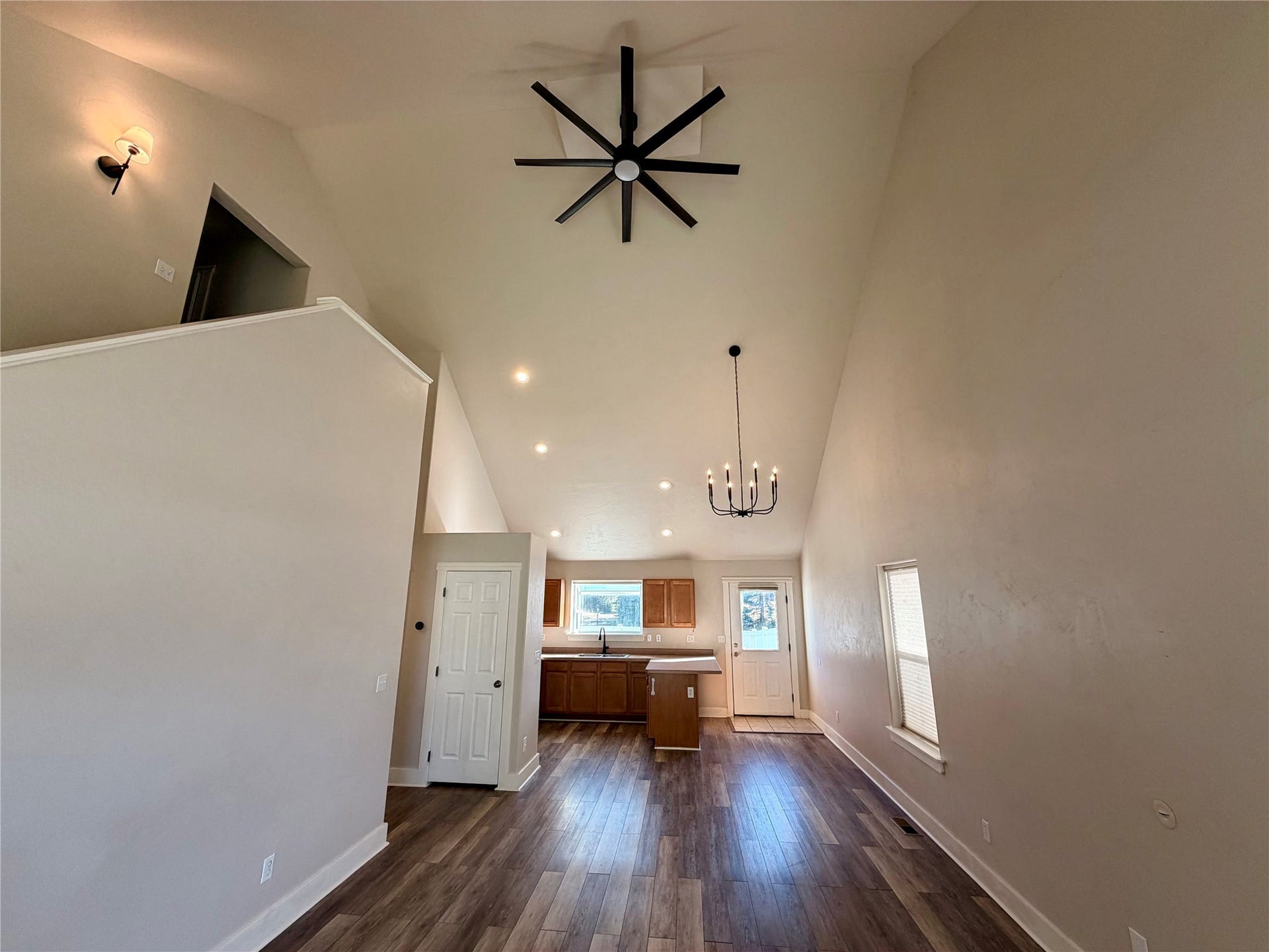 2 Empire Loop, Kalispell, MT 59901 Open concept Kitchen, dining, and living room with high vaulted ceilings and abundant natural light.