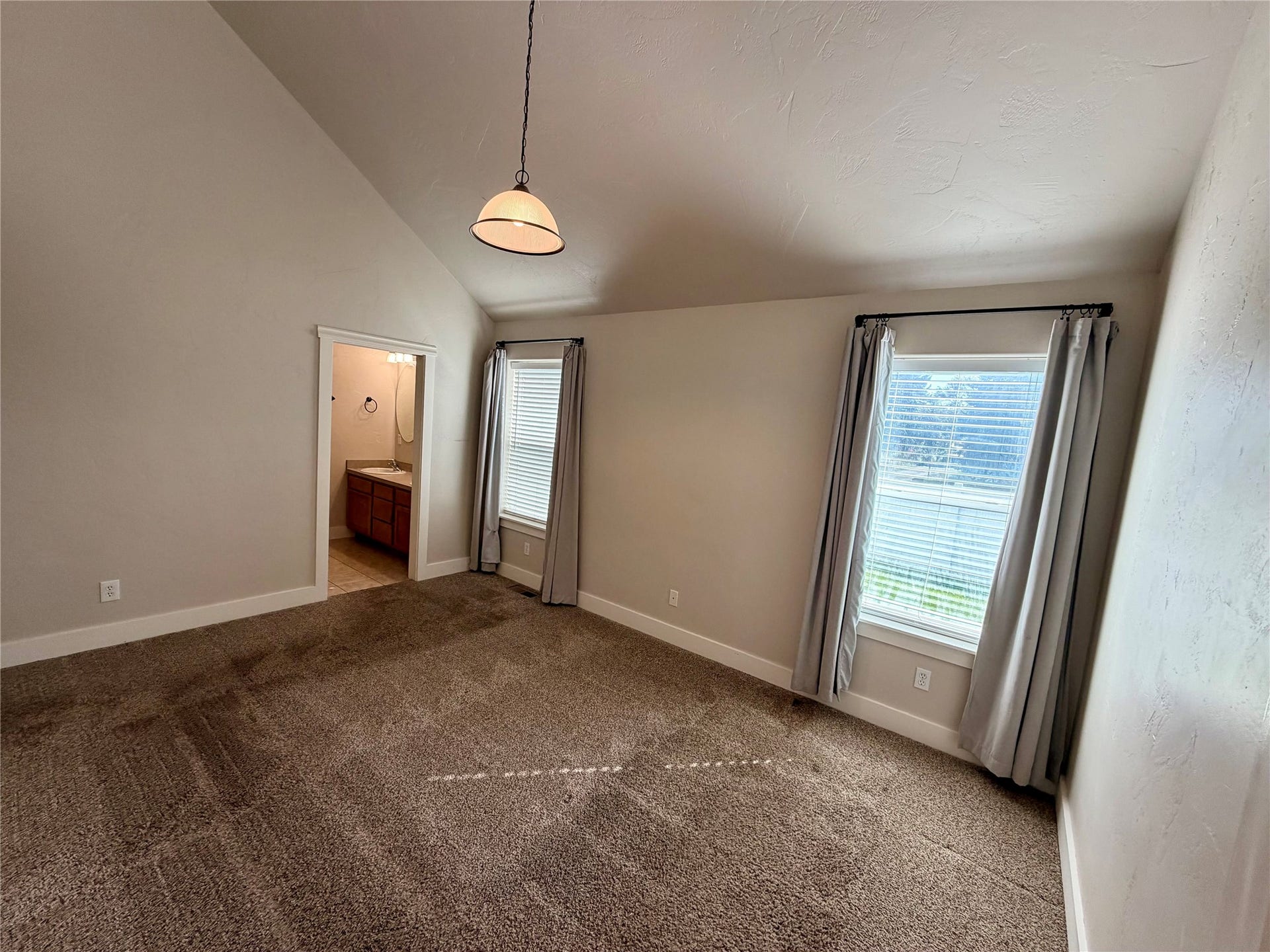 2 Empire Loop, Kalispell, MT 59901 Spacious main level primary suite bedroom with attached bath with dual sinks in a 3-bedroom North Kalispell townhome.