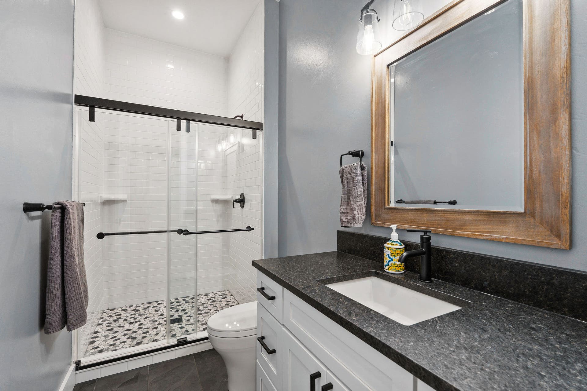 14051 Big Rock Way, Bigfork, MT 59911 Main level ensuite 3/4 bath w/ granite countertops & slate floor