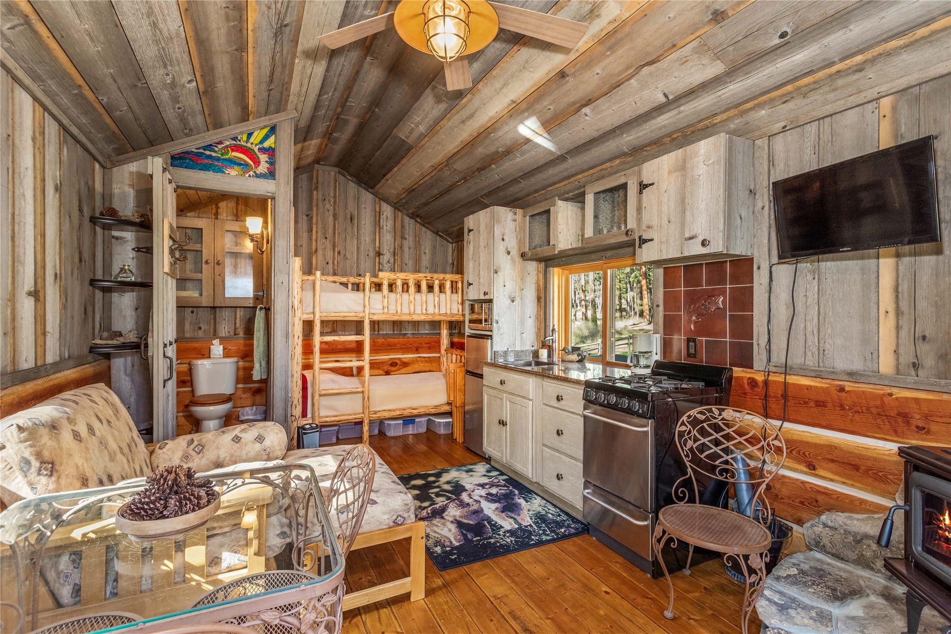 13518 Sylvan Drive, Bigfork, MT 59911 Eagles Nest living room & kitchen area with wood stove