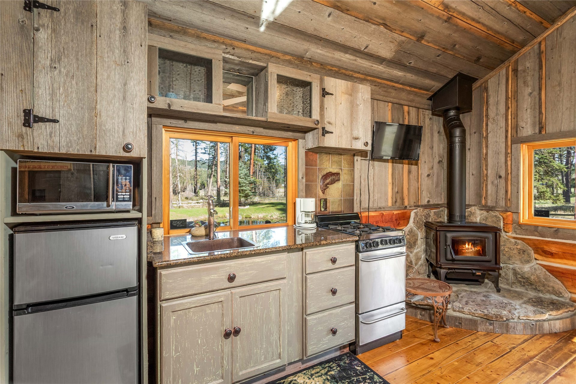 13518 Sylvan Drive, Bigfork, MT 59911 Eagles Nest Cabin kitchen area complete with wood stove