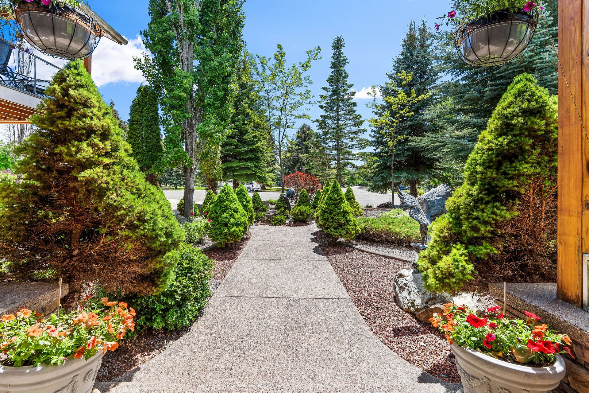 229 Harbor Drive, Bigfork, MT 59911 Concrete walkway with landscaping and sculptures, view from front porch