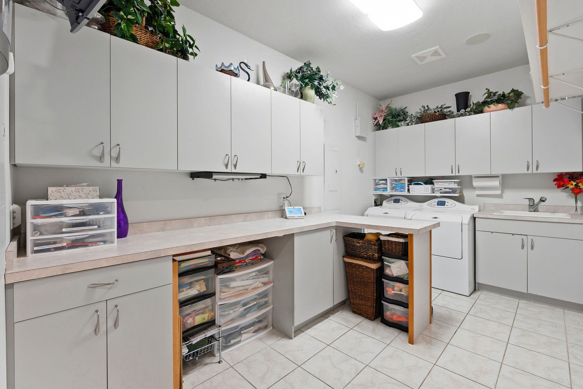 229 Harbor Drive, Bigfork, MT 59911 Main level multipurpose laundry room with cabinets, countertops, and sink
