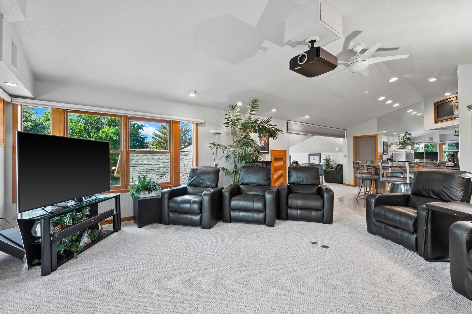 229 Harbor Drive, Bigfork, MT 59911 Theater Room with automatic blackout blinds on windows and blackout blind by bar to make room private and dark