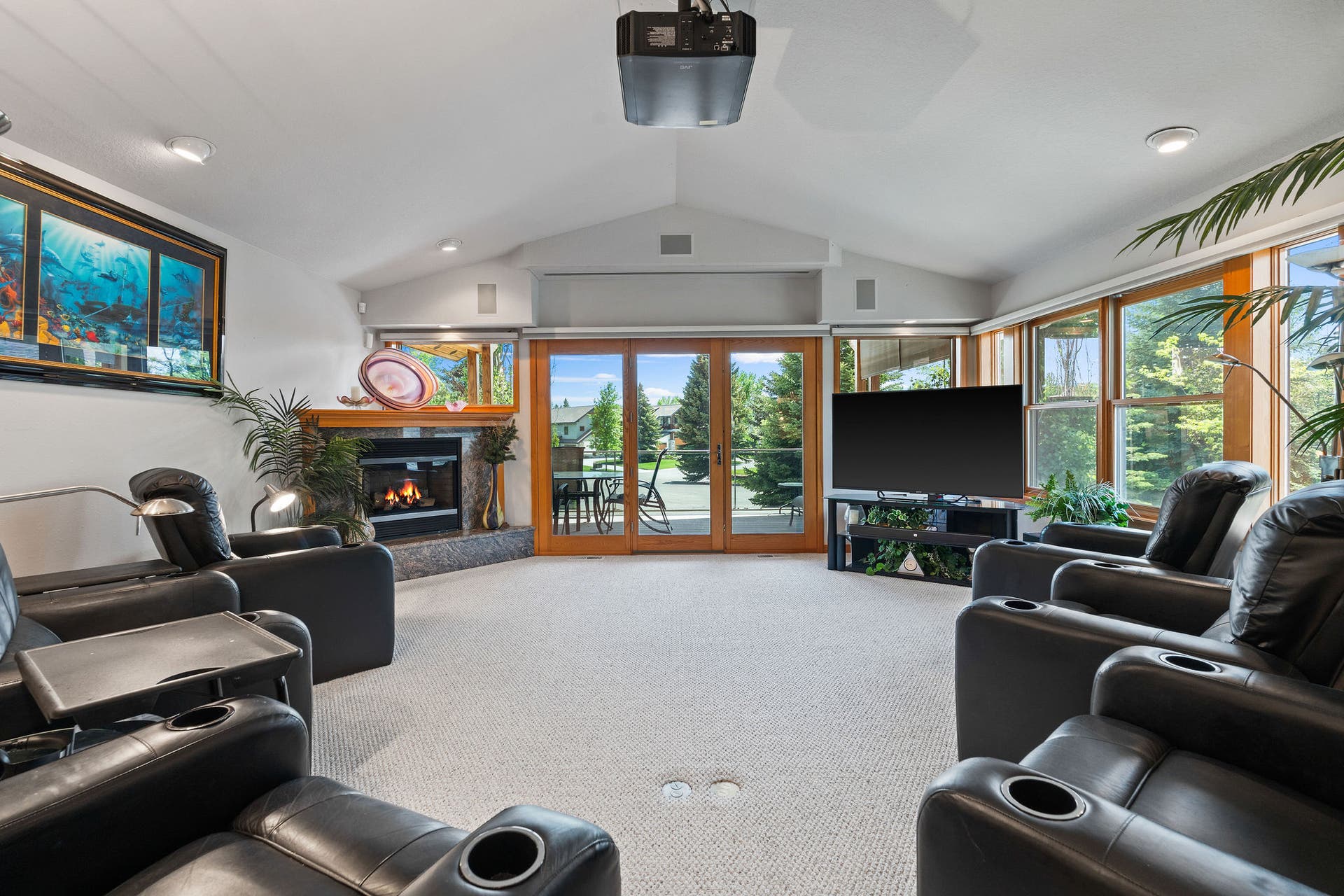 229 Harbor Drive, Bigfork, MT 59911 Theater Room has corner fireplace with granite surround and wood mantle