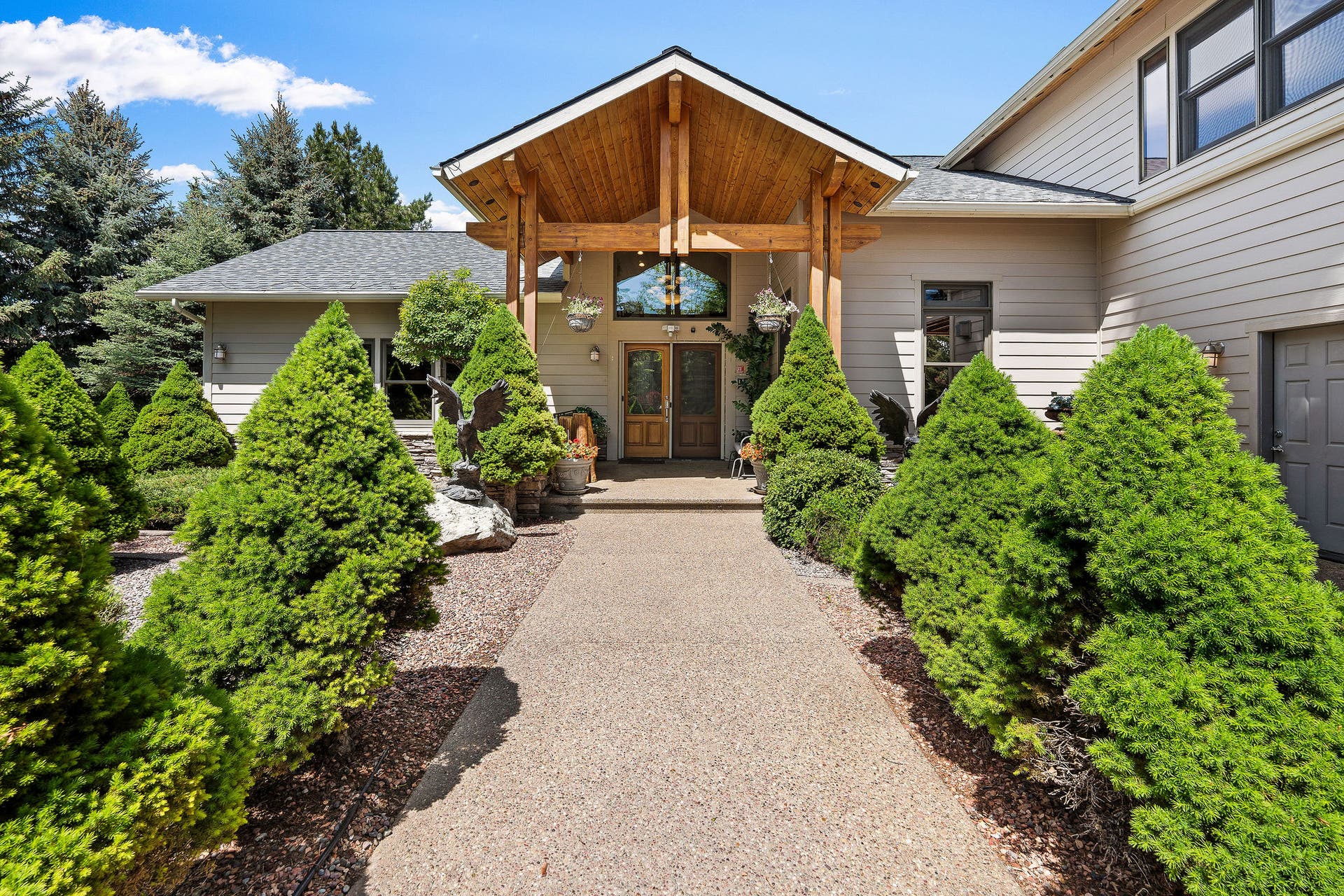 229 Harbor Drive, Bigfork, MT 59911 Beautiful landscaping and concrete walkway to front entry