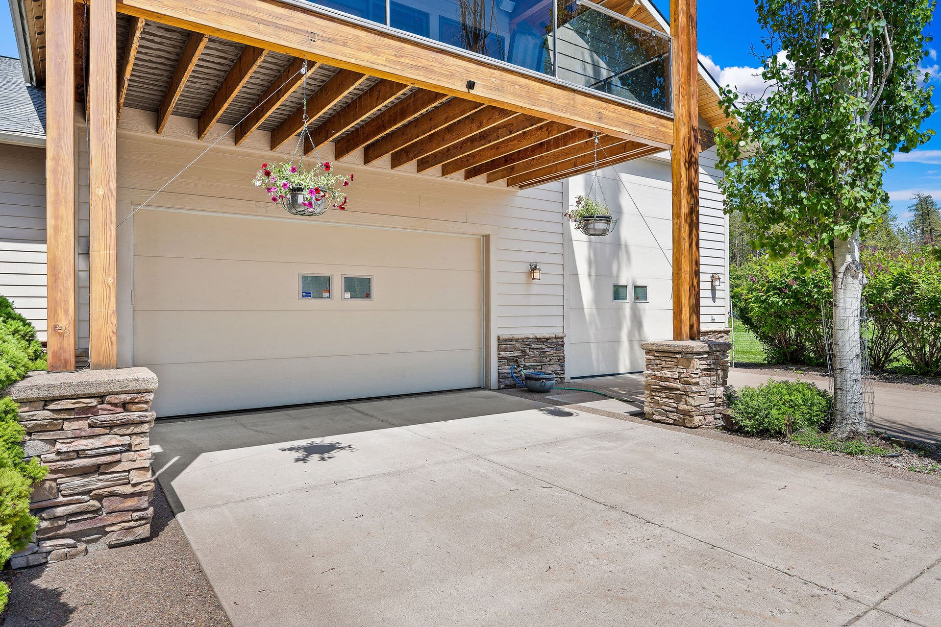 229 Harbor Drive, Bigfork, MT 59911 Front driveway and garage #1 and #2 doors