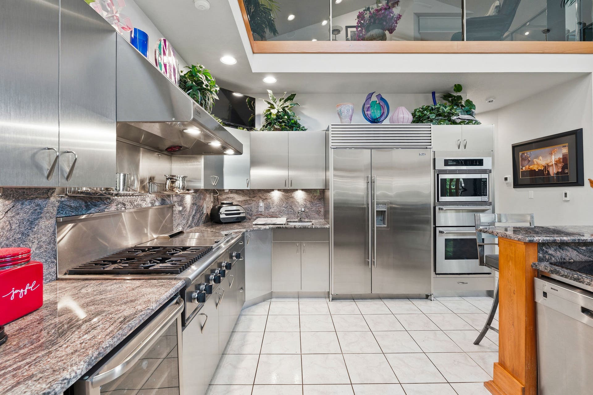 229 Harbor Drive, Bigfork, MT 59911 Beautiful kitchen with stainless-steel appliances, custom stainless steel cabinet fronts, and