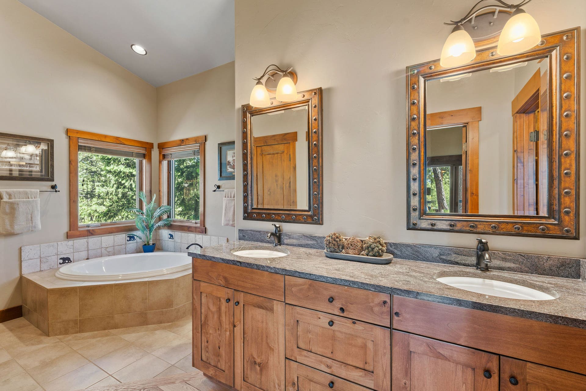 129 Bjork Drive, Bigfork, MT 59911 Large full ensuite private bath, dual vanity sinks, granite countertop, knotty alder cabinets