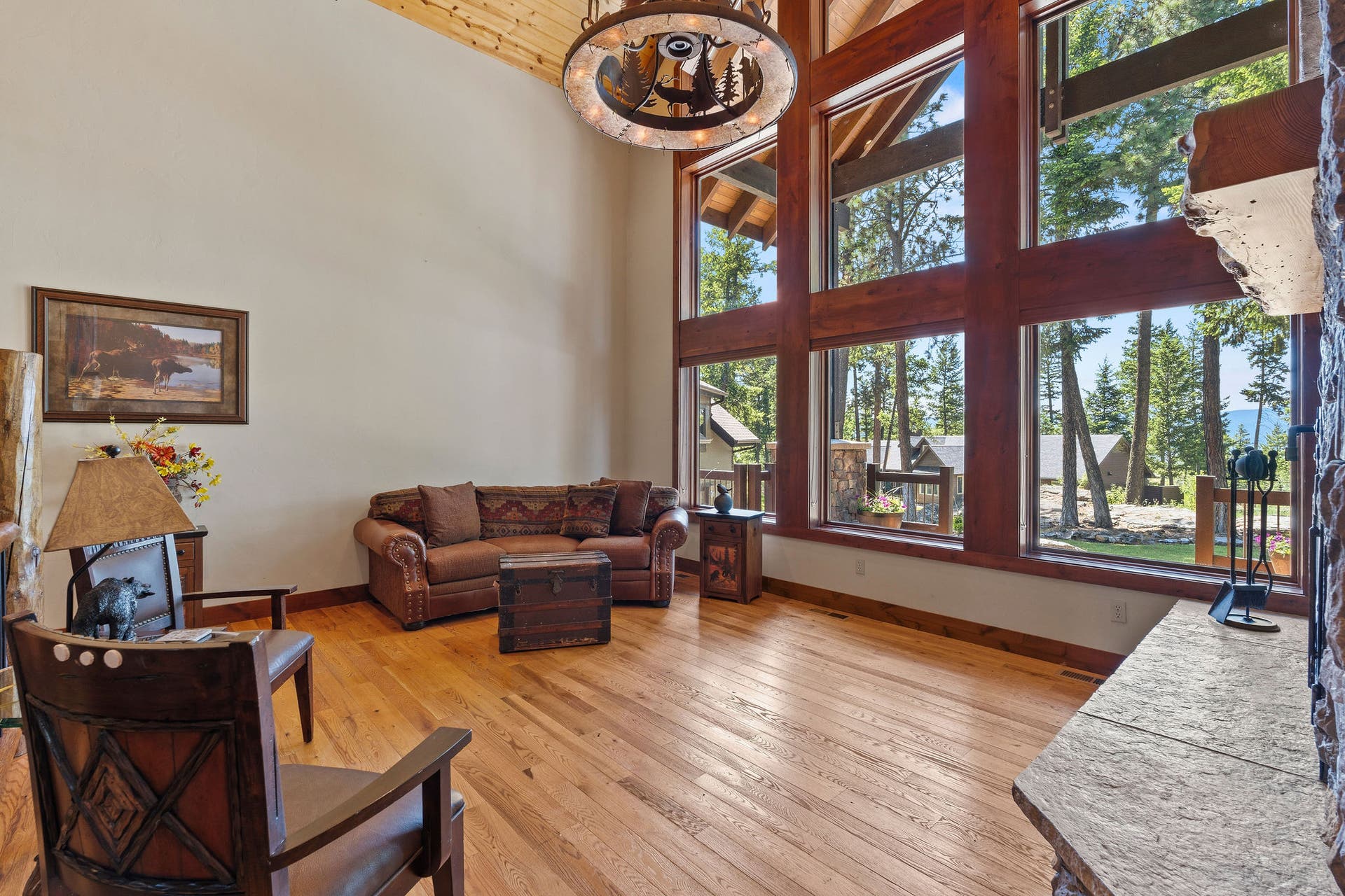 129 Bjork Drive, Bigfork, MT 59911 Custom chandelier with rim from Oregon Trail wagon wheel, floor-to ceiling windows with sun rollouts