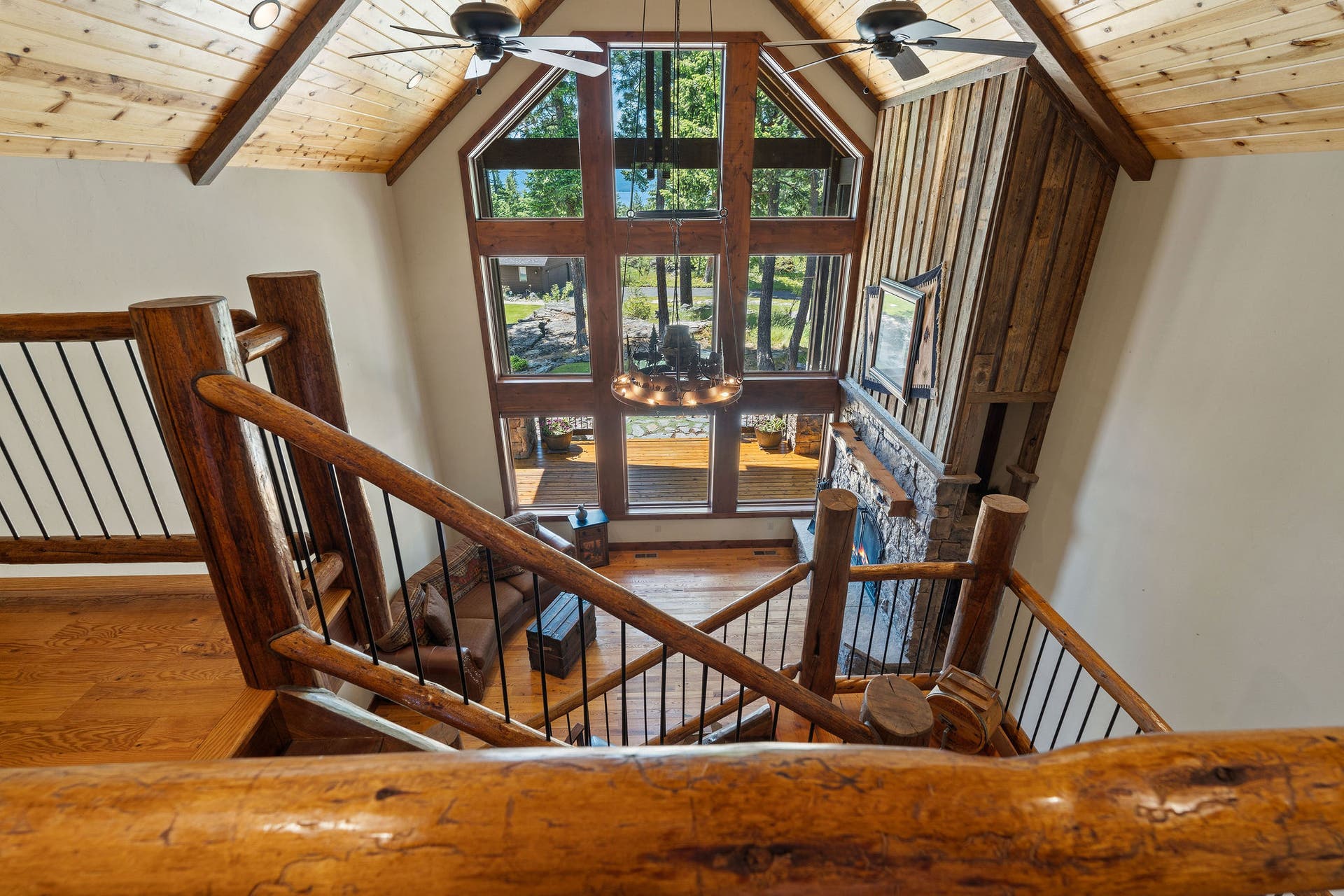 129 Bjork Drive, Bigfork, MT 59911 3-level log staircase with rare long needle pine on each landing & black rod iron pickets, Swan Mtn & Flathead Lake views