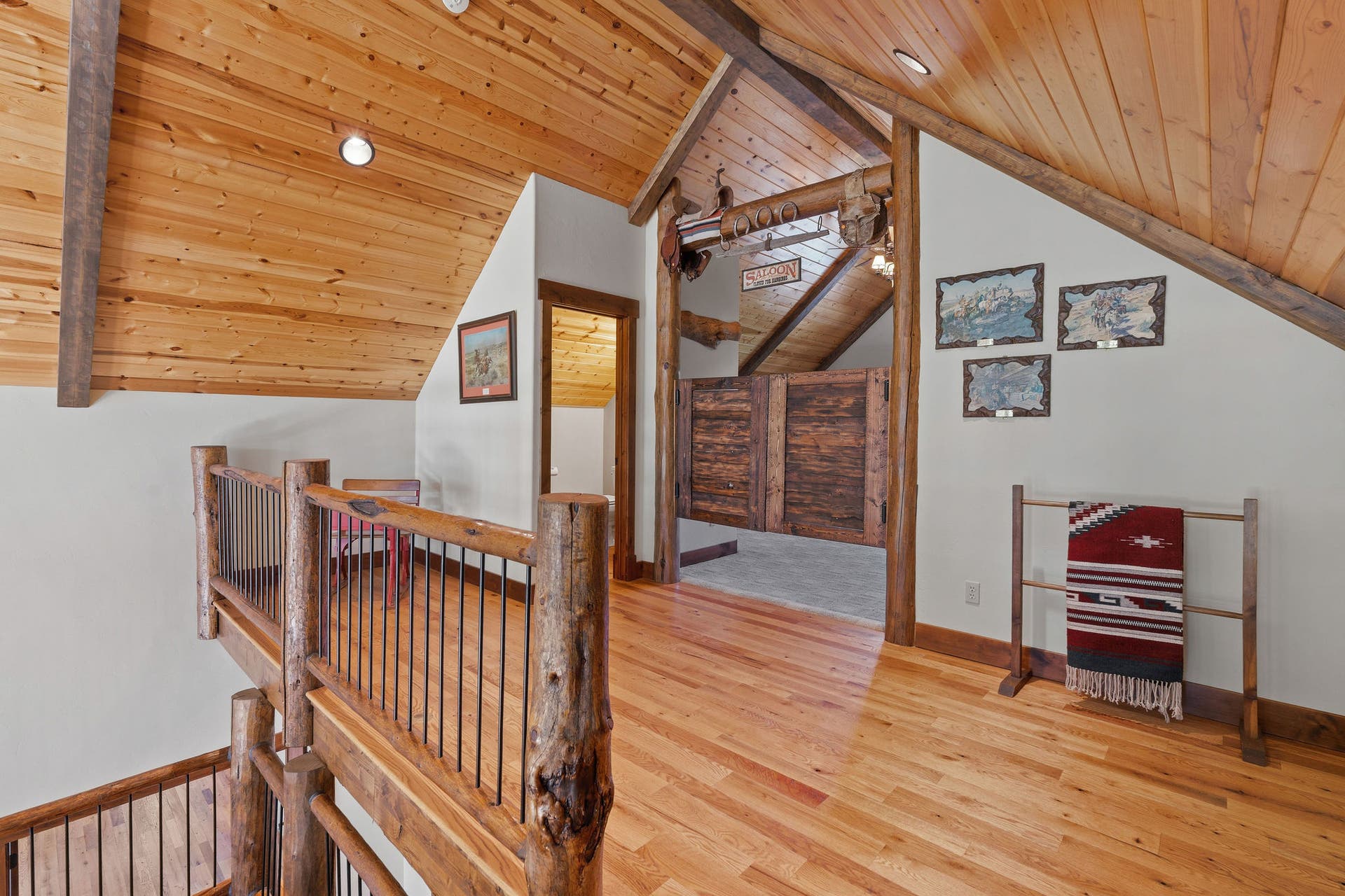 129 Bjork Drive, Bigfork, MT 59911 Wood flooring, log & iron railing