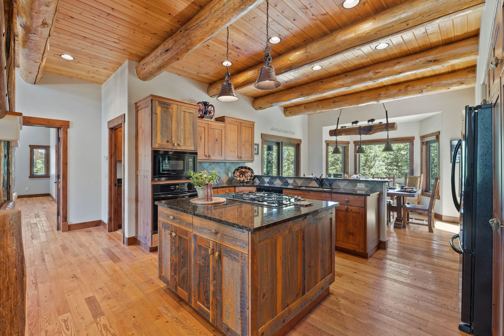 129 Bjork Drive, Bigfork, MT 59911 Granite countertops, slate tile backsplash, custom knotty alder cabinets, barnwood accents on island