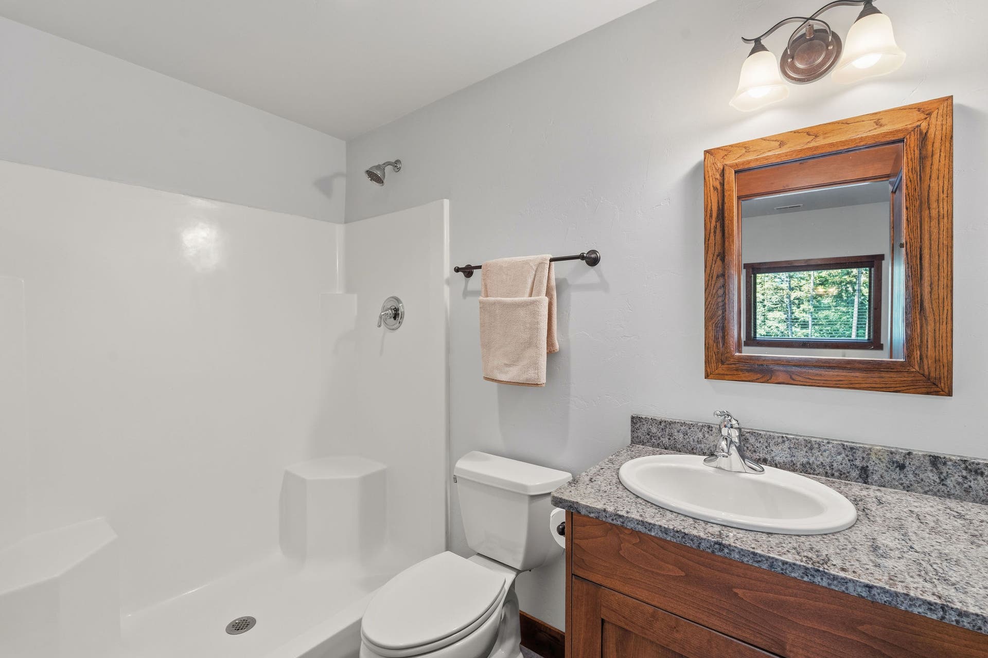 129 Bjork Drive, Bigfork, MT 59911 Ensuite 3/4 bath with granite countertop, tile floor, knotty alder cabinets