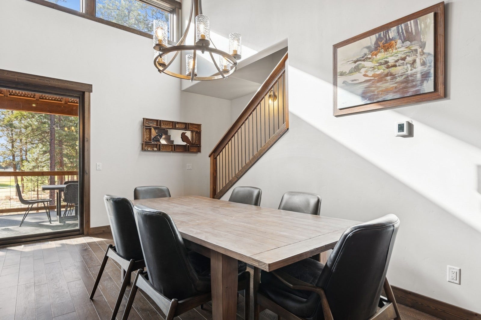 30 Boulder Lane, Eureka, MT 59917 Dining area featuring dark wood-style flooring, stairway, baseboards, and an inviting chandelier