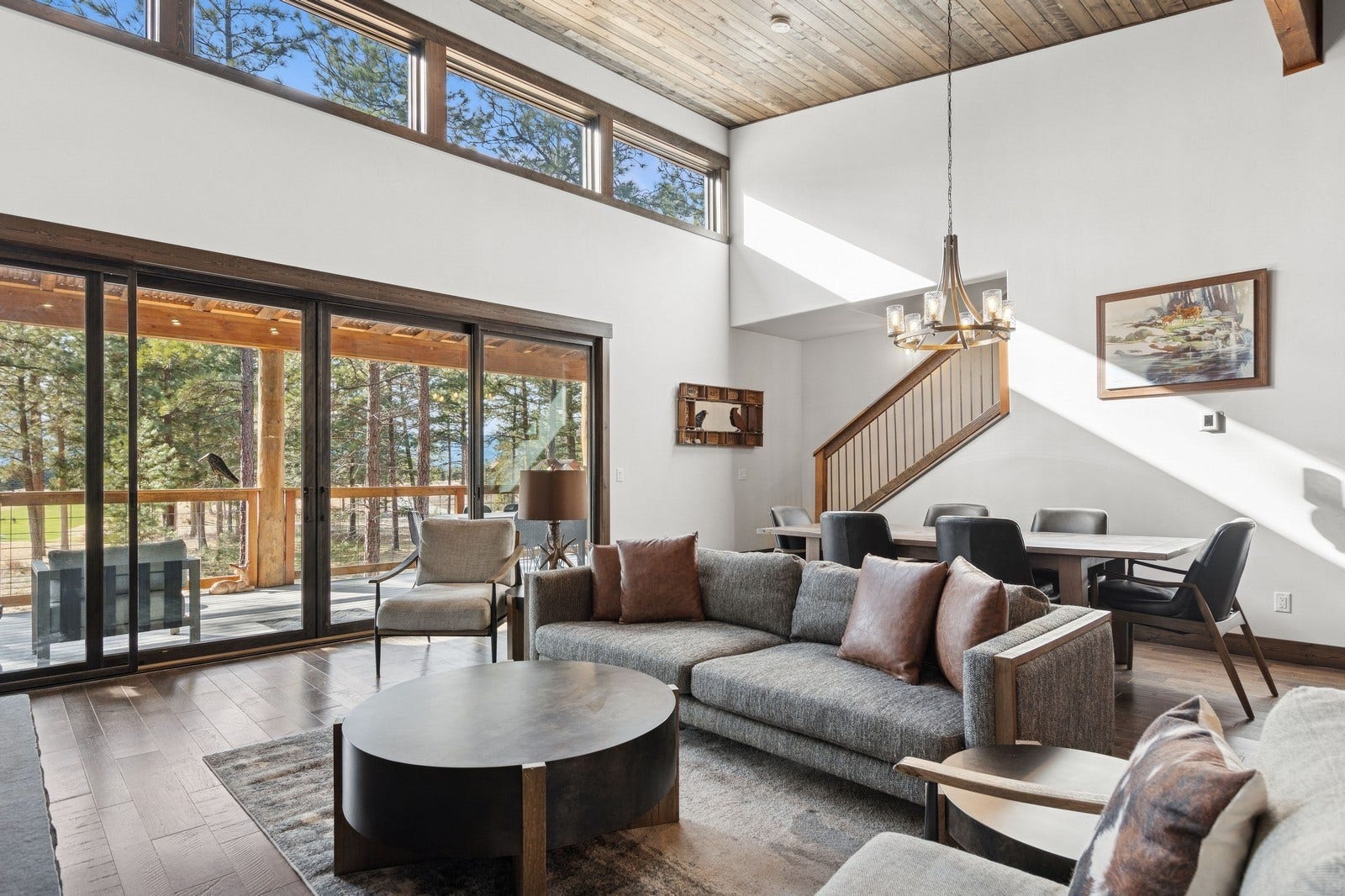 30 Boulder Lane, Eureka, MT 59917 Living area with wood finished floors, a towering ceiling, wood ceiling, stairs, and an inviting chandelier