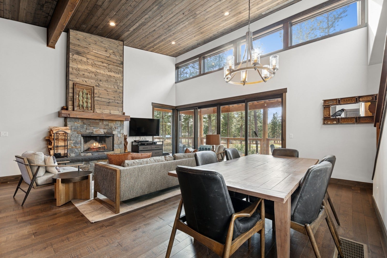 30 Boulder Lane, Eureka, MT 59917 Dining room with dark wood-style floors, a fireplace, a wealth of natural light, a chandelier, and wooden ceiling