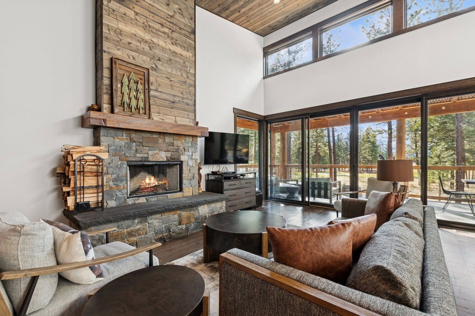 30 Boulder Lane, Eureka, MT 59917 Living area with wood ceiling, a fireplace, a towering ceiling, and wood finished floors