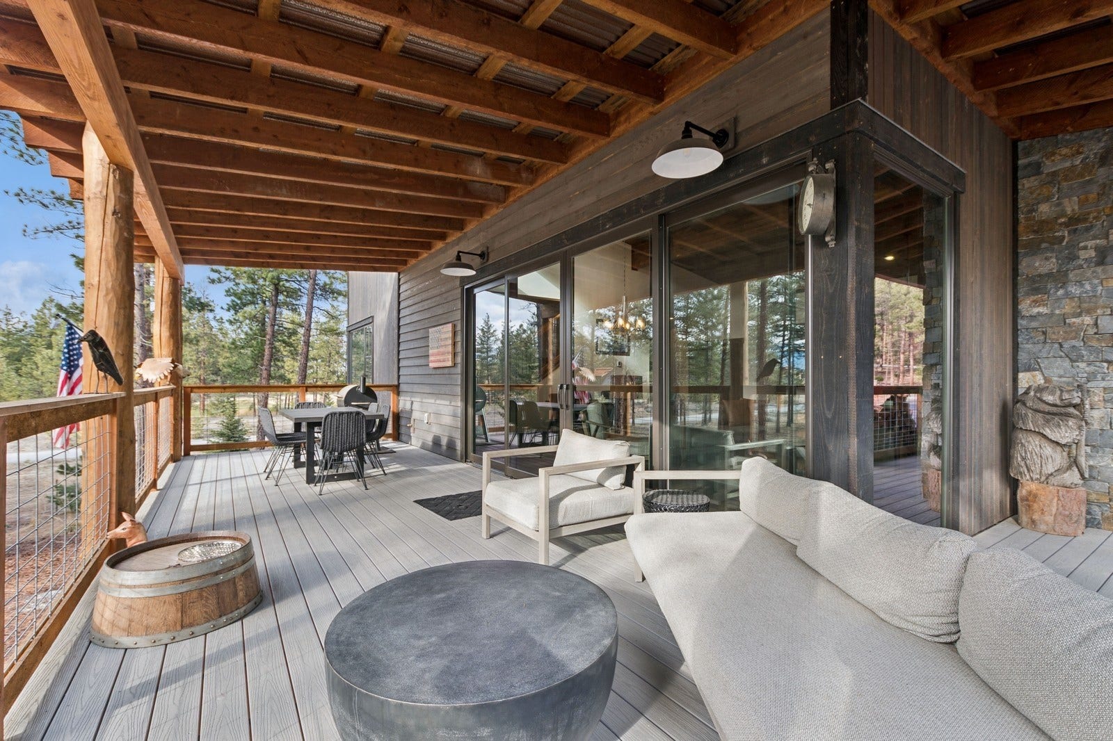 30 Boulder Lane, Eureka, MT 59917 Wooden terrace with outdoor dining space and an outdoor hangout area