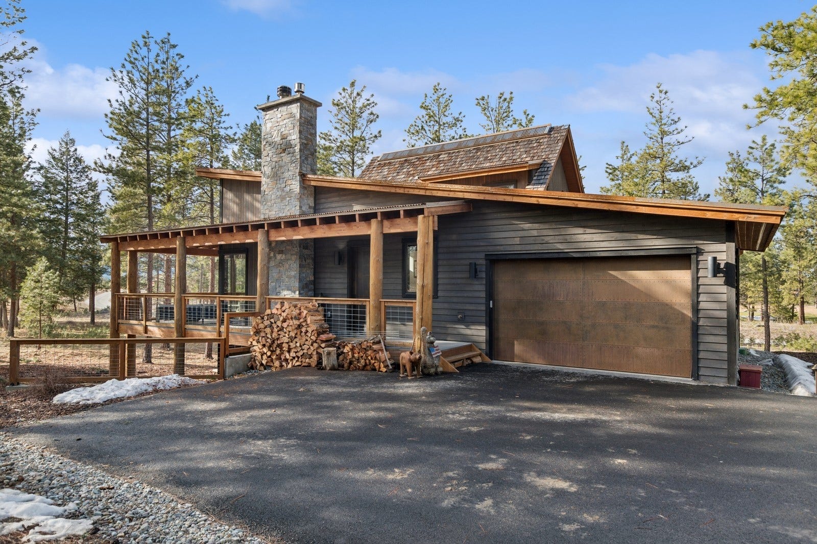 30 Boulder Lane, Eureka, MT 59917 Chalet / cabin with a garage, a chimney, and aphalt driveway