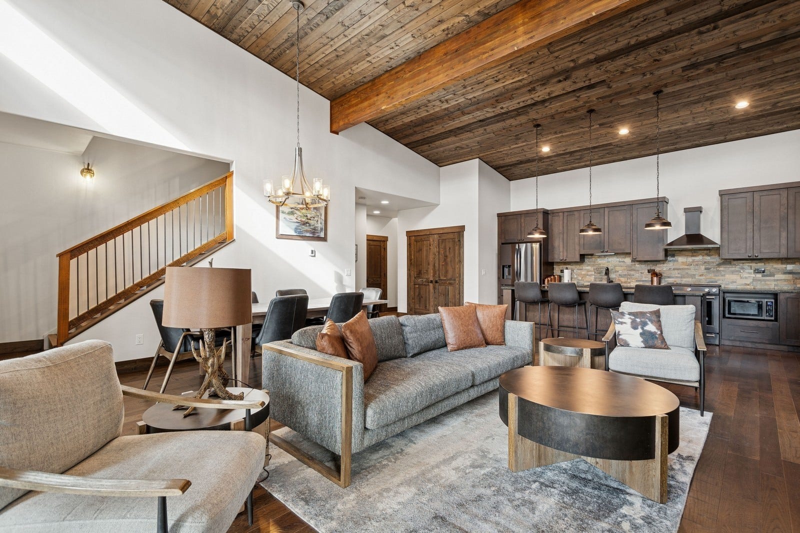 30 Boulder Lane, Eureka, MT 59917 Living area featuring dark wood-style floors, wood ceiling, stairway, and beamed ceiling