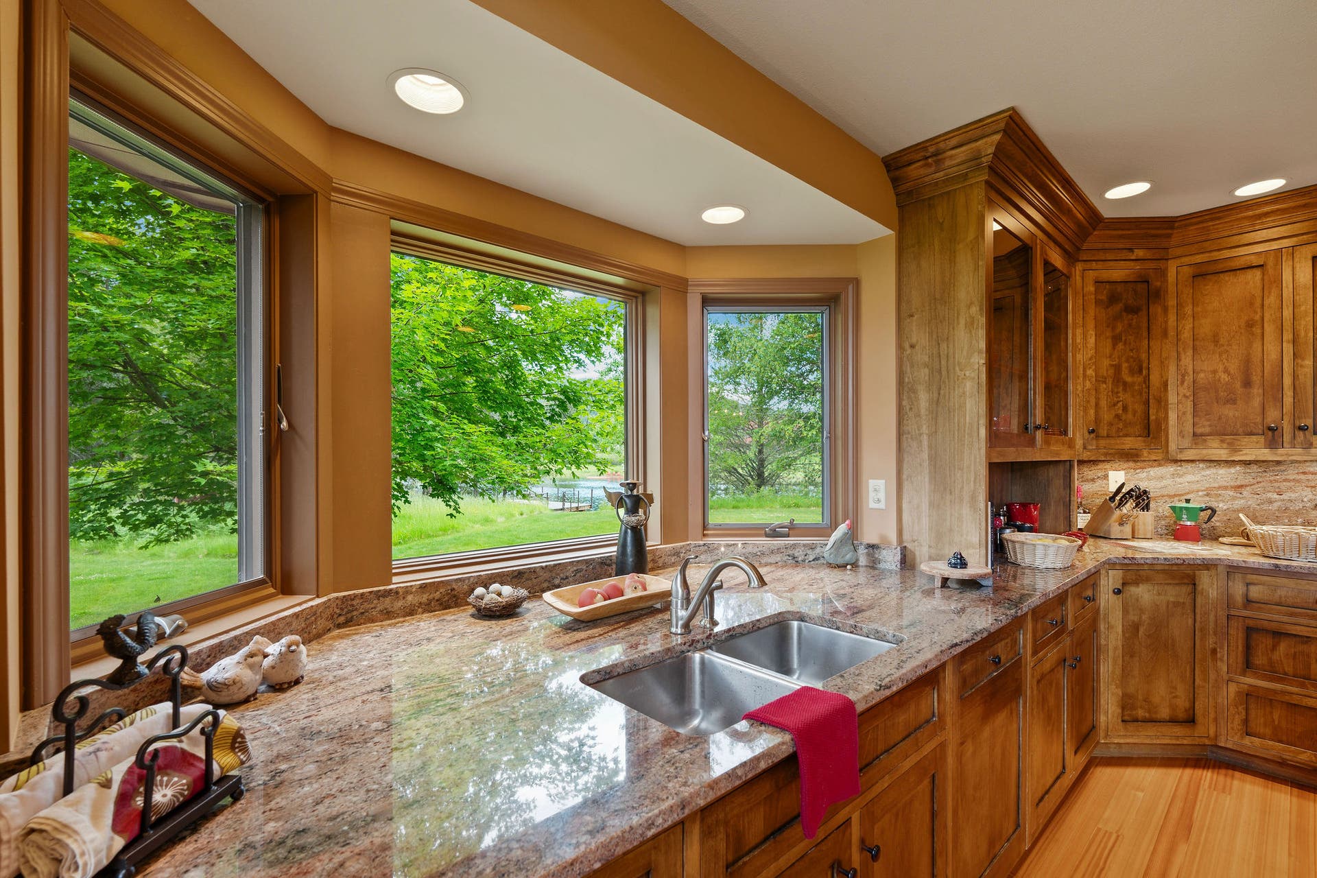 1160 Swan Horseshoe Drive, Bigfork, MT 59911 Kitchen sink window looking out toward the river and the perfectly landscaped yard