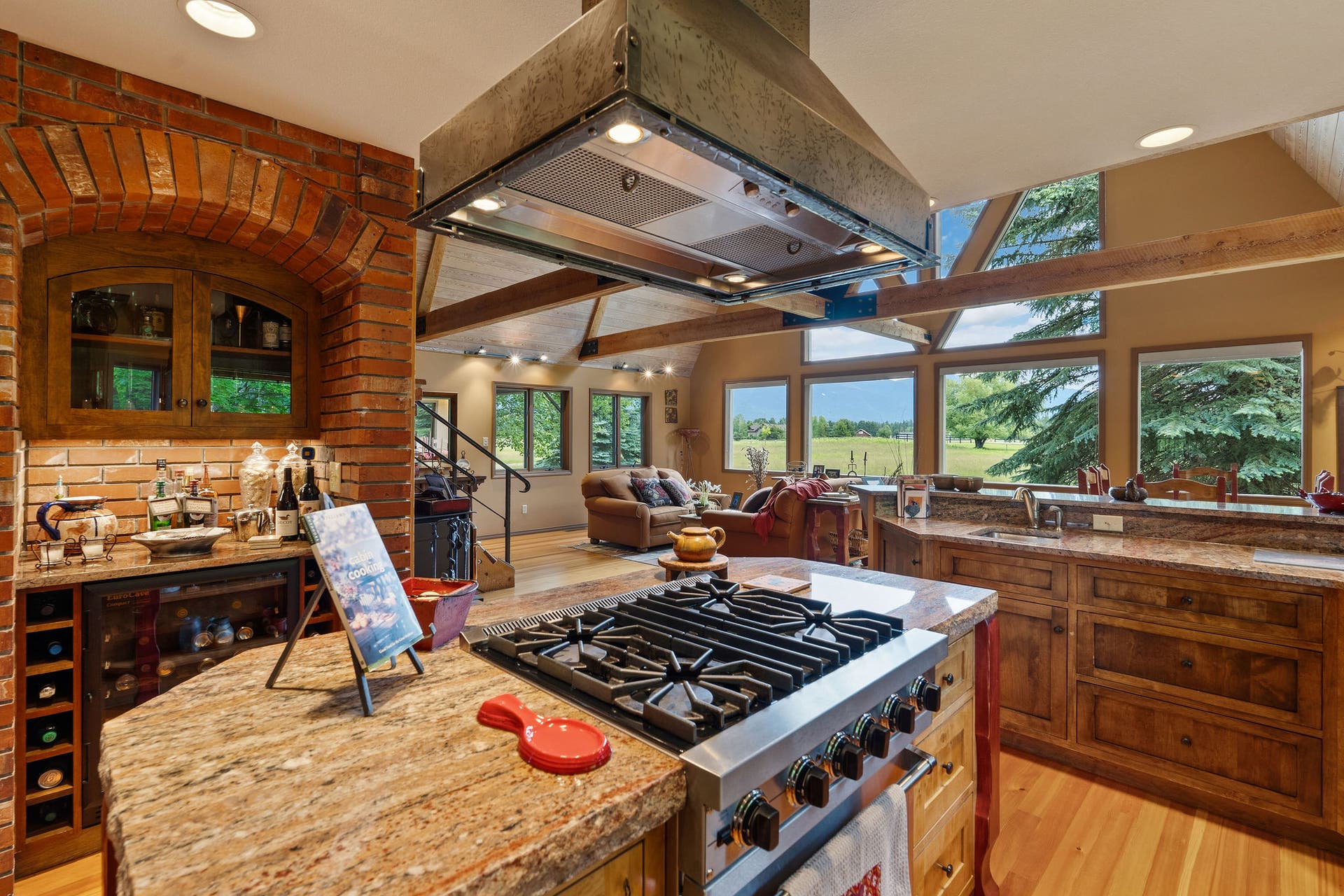 1160 Swan Horseshoe Drive, Bigfork, MT 59911 Kitchen Island with Brick wine and coffee bar behind