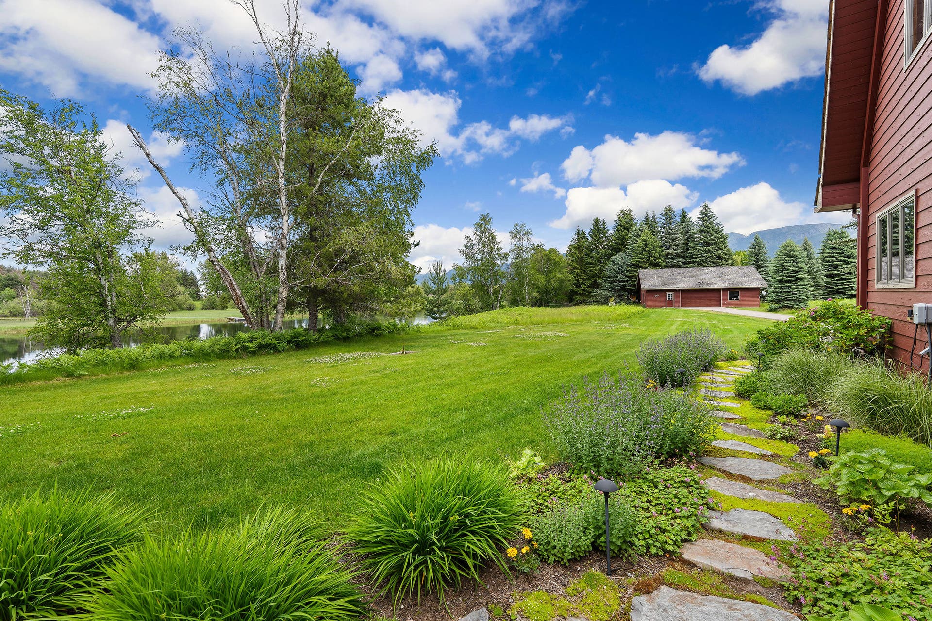 1160 Swan Horseshoe Drive, Bigfork, MT 59911 Back yard - Stepping stones to garage entry