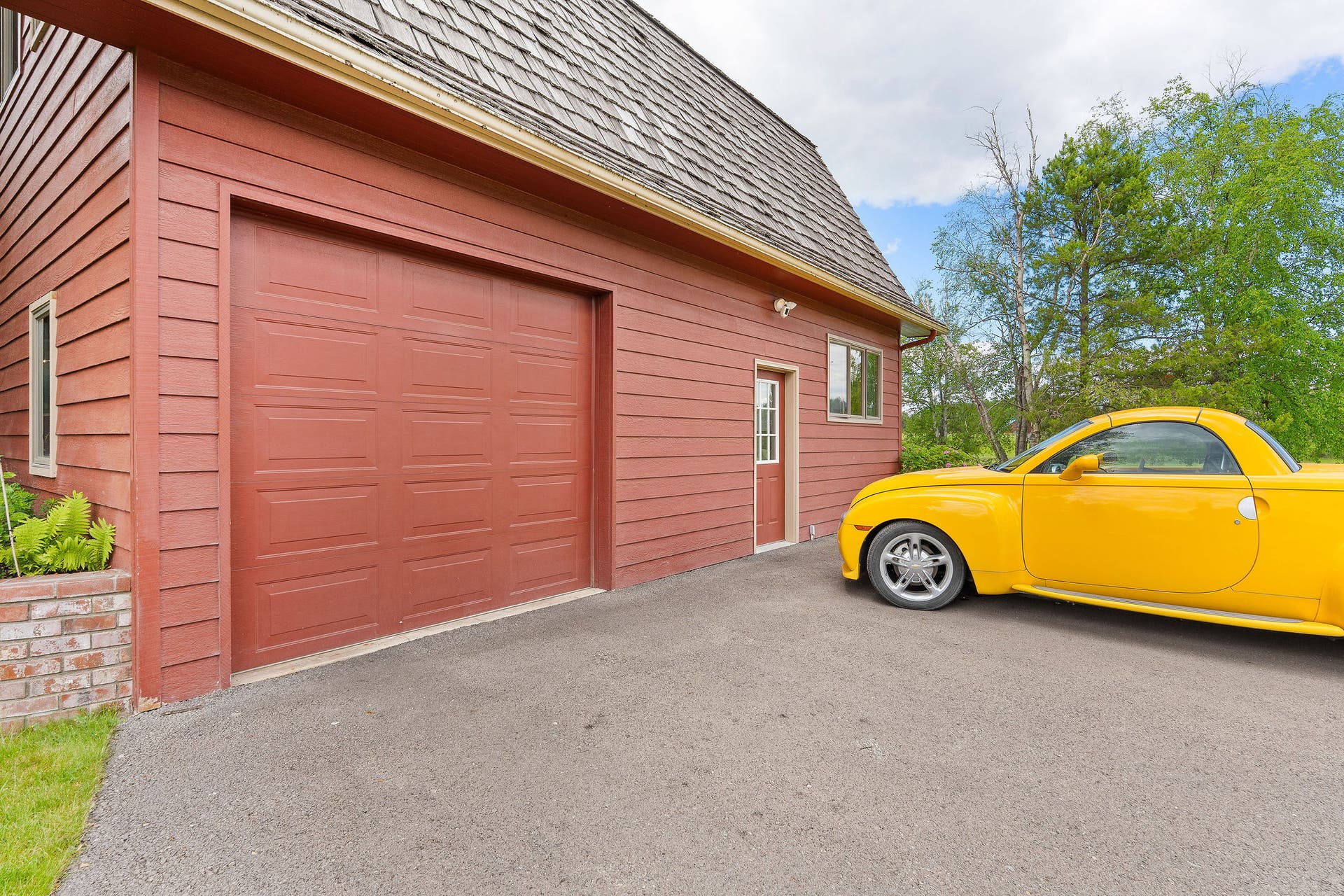 1160 Swan Horseshoe Drive, Bigfork, MT 59911 Driveway, parking area, and garage, along with the entrance to the guest apartment.